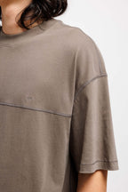 Cabin Smoke | On Model Front Detail Close-up of a person wearing a brown t-shirt on a white background