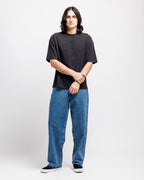 Ink Black | On Model Full Front Person wearing a black t-shirt and blue jeans on a white background