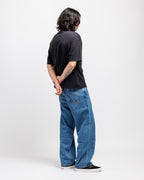 Ink Black | On Model Full Back Person wearing a black t-shirt and blue jeans standing against a white background