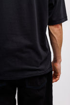 Ink Black | On Model Back Detail Person wearing a black t-shirt and pants on a white background
