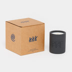 Black candle in a box with branding on a white background