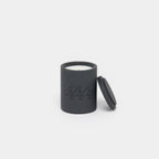 Black candle with lid on a white background