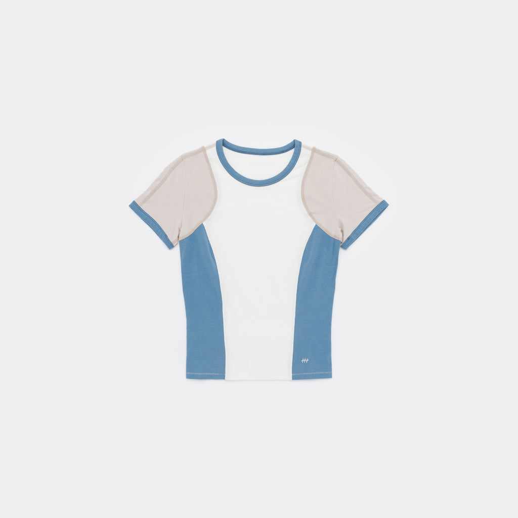 A short-sleeve ringer t-shirt with a colorblock design, featuring a white center panel, light blue side panels and collar trim, and beige shoulder yokes, shown flat on a light gray background.