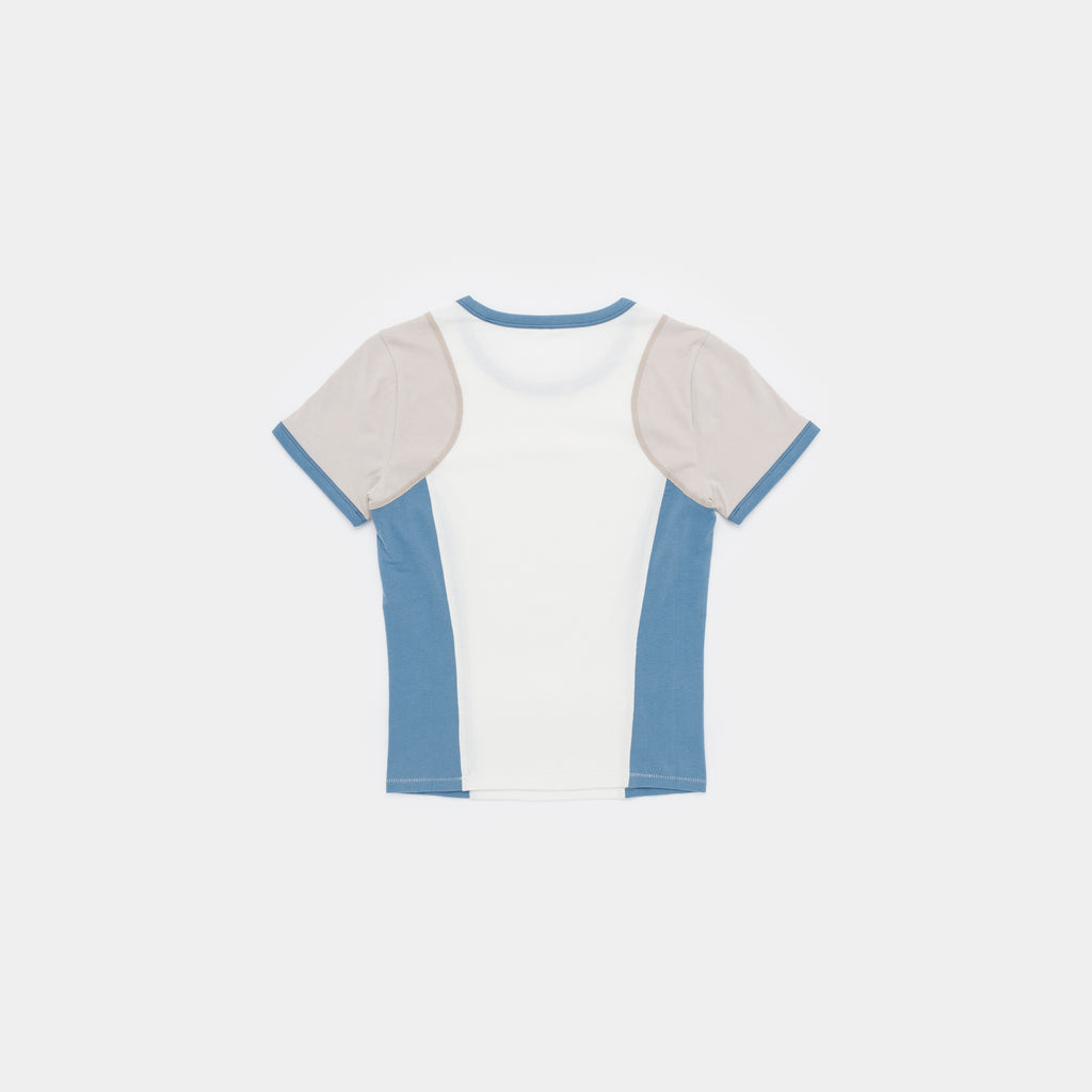 A short-sleeve ringer t-shirt with a white body, light beige shoulder panels, and dusty blue side panels and collar trim, shown flat on a light gray background.