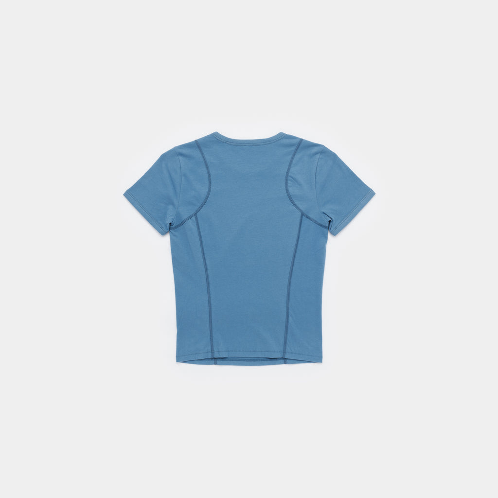 A short-sleeve athletic t-shirt shown from the back, featuring integrated seam panels and a crew neck, in a dusty medium blue color, displayed on a clean light gray background.