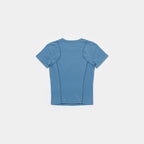 Frostbite Blue | Back A short-sleeve athletic t-shirt shown from the back, featuring integrated seam panels and a crew neck, in a dusty medium blue color, displayed on a clean light gray background.