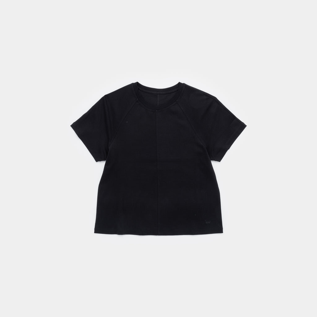A black short-sleeve crop top with raglan sleeves, laid flat against a light gray background.