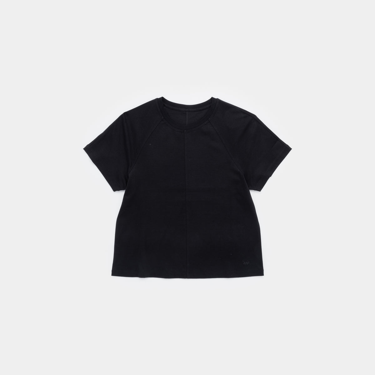 A black short-sleeve crop top with raglan sleeves, laid flat against a light gray background.
