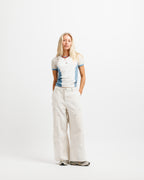 Cougar Milk / Frostbite Blue / Silver Tip | On Model Full Front A short-sleeve ringer t-shirt with a white body, light beige shoulder panels