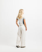 Cougar Milk / Frostbite Blue / Silver Tip | On Model Full Back A woman with long blonde hair is shown from behind wearing a light gray t-shirt with blue side panels and off-white wide-leg jeans, standing against a solid white studio background.