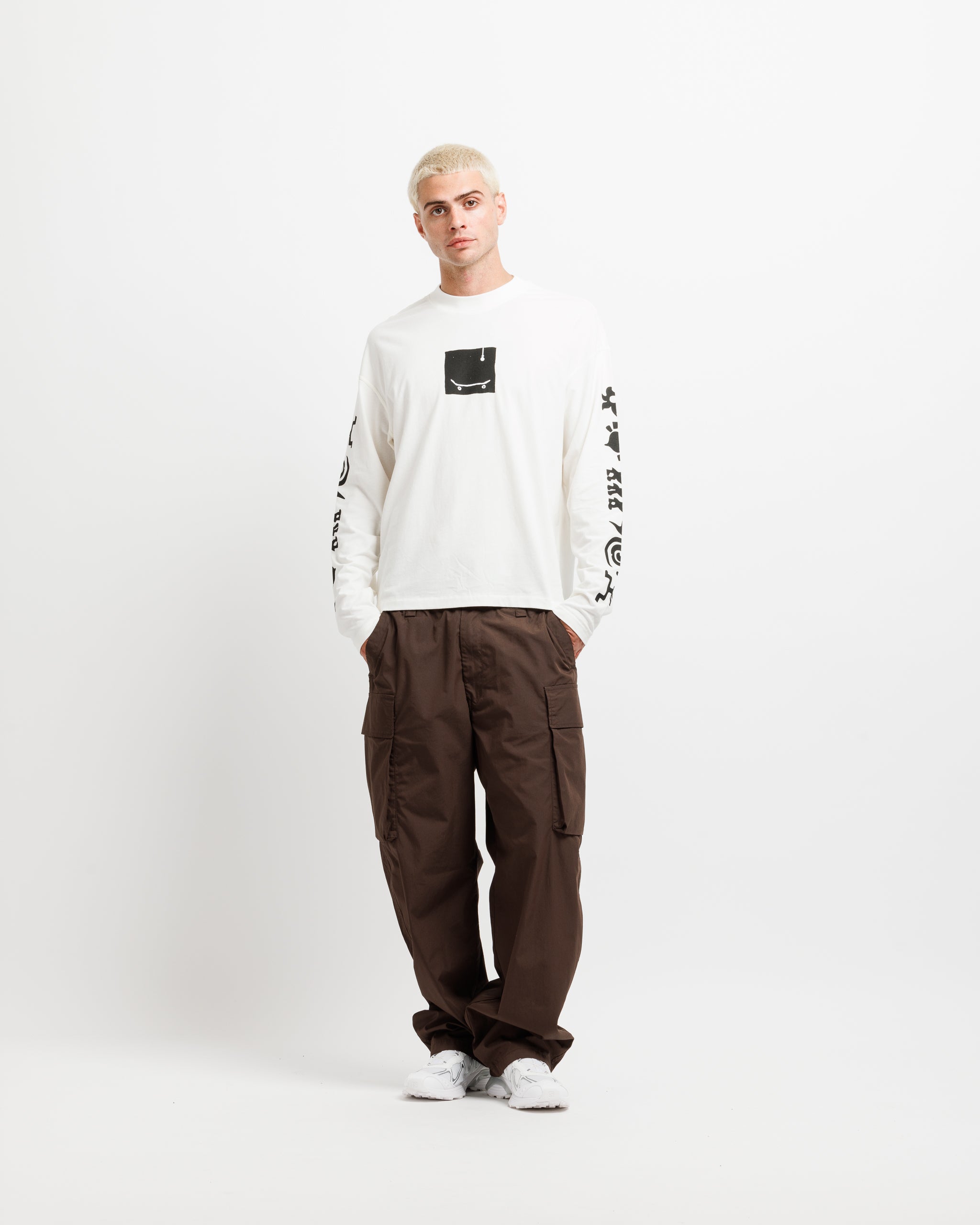 White Westbeach long sleeve tee with a black heritage graphic featuring a light bulb, a skateboard board, and classic Westbeach iconography on the sleeves. 