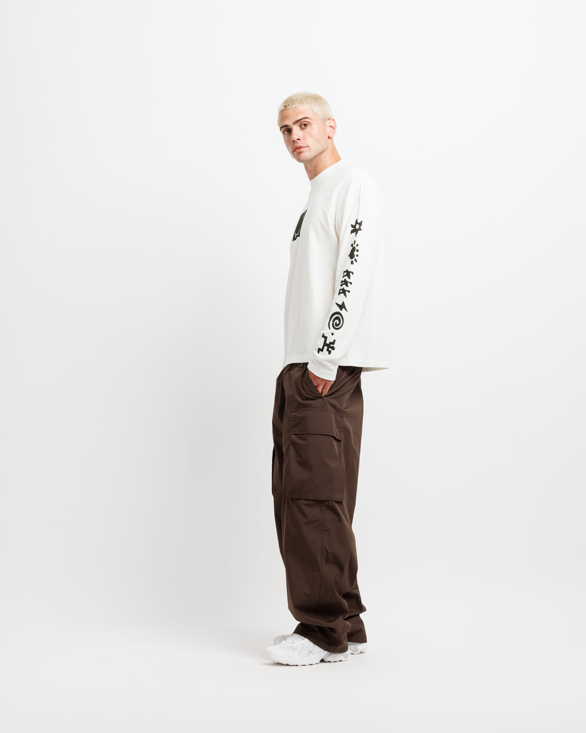 White Westbeach long sleeve tee with a black heritage graphic featuring a light bulb, a skateboard board, and classic Westbeach iconography on the sleeves. 
