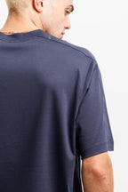 Deepwater Navy | On Model Back Close-up back view of a man wearing a dark navy blue short-sleeve t-shirt against a plain white background.